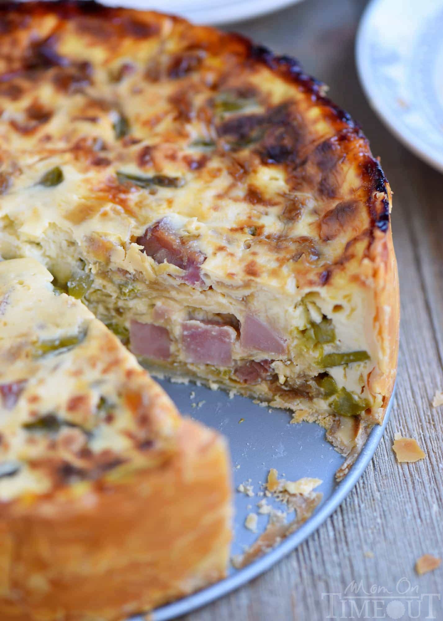 This Deep Dish Ham and Asparagus Quiche with caramelized onions is the perfect addition to your holiday brunch menu! Make it the day before and serve cold or room temperature - both ways are delicious! Also makes a hearty dinner! // Mom On Timeout