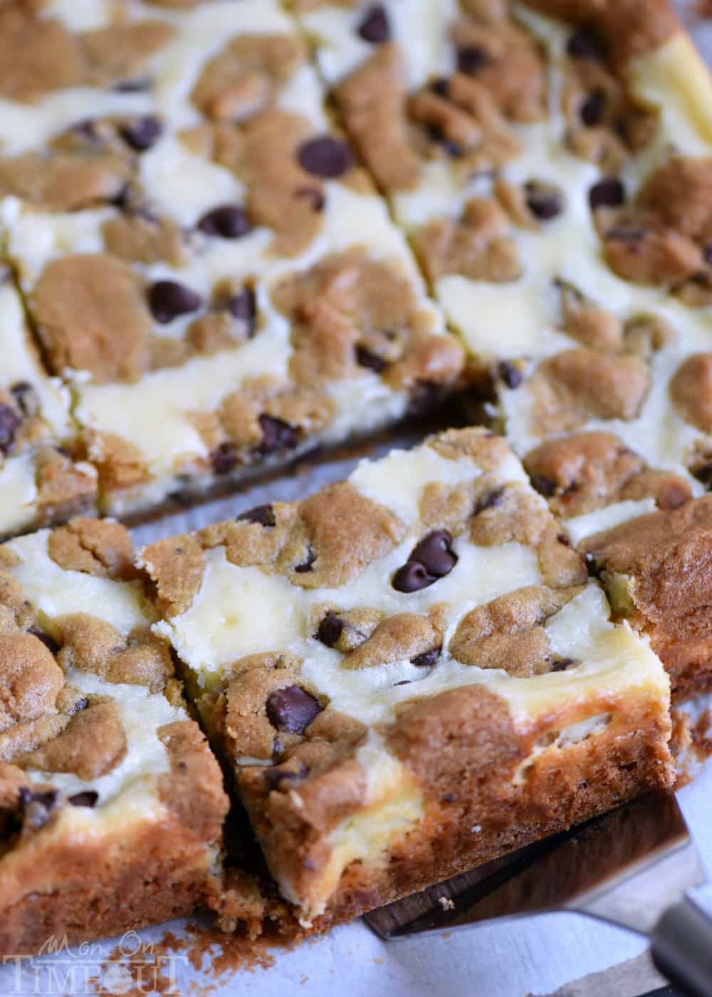 These easy Chocolate Chip Cookie Cheesecake Bars are made with just five ingredients! This easy dessert recipe will satisfy all your cravings! // Mom On Timeout #cheesecake #recipe #chocolate #dessert