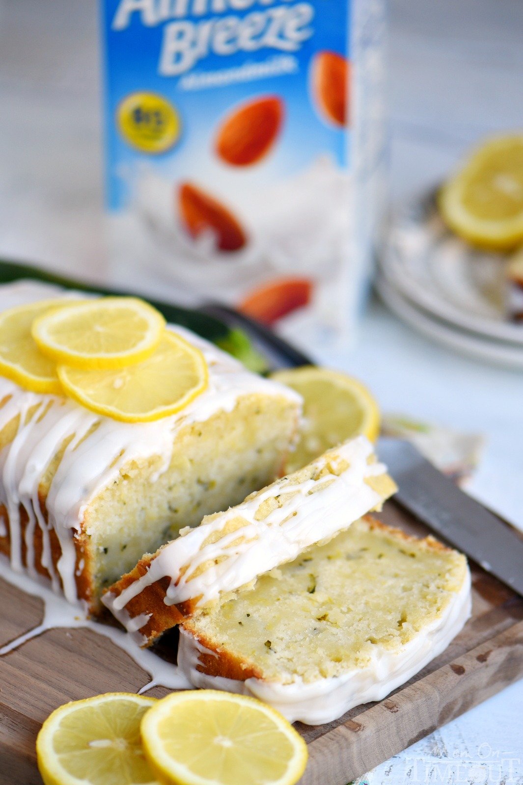 This Lemon Zucchini Cake is definitive proof that lemon and zucchini belong together! Beautifully moist and undeniably delicious, this easy cake is topped with a lemon glaze that will keep you coming back for one more slice.  An excellent way to use up that zucchini from your garden! // Mom On Timeout