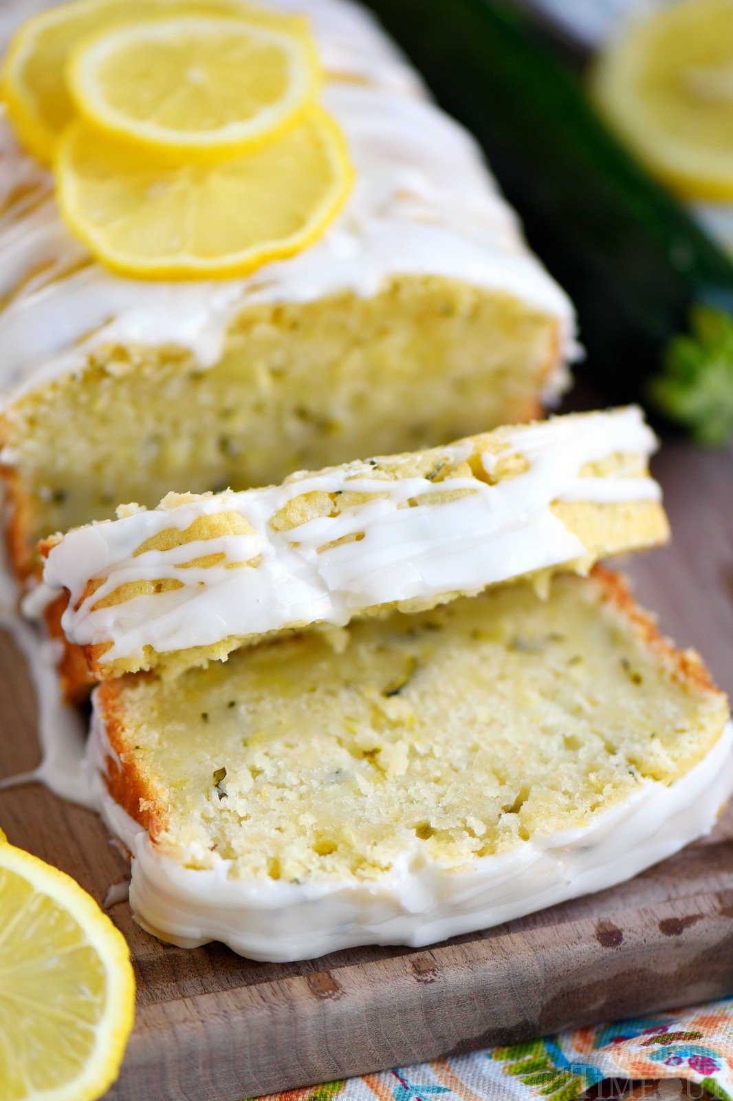 This Lemon Zucchini Cake is definitive proof that lemon and zucchini belong together! Beautifully moist and undeniably delicious, this easy cake is topped with a lemon glaze that will keep you coming back for one more slice.  An excellent way to use up that zucchini from your garden! // Mom On Timeout