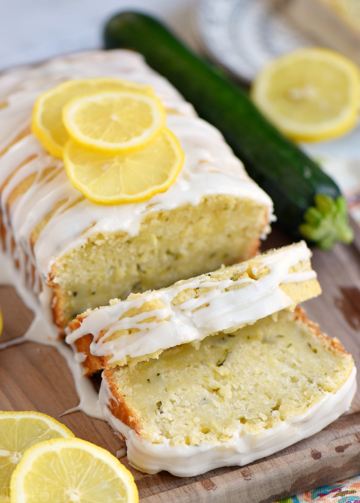 This Lemon Zucchini Cake is definitive proof that lemon and zucchini belong together! Beautifully moist and undeniably delicious, this easy cake is topped with a lemon glaze that will keep you coming back for one more slice.  An excellent way to use up that zucchini from your garden! // Mom On Timeout