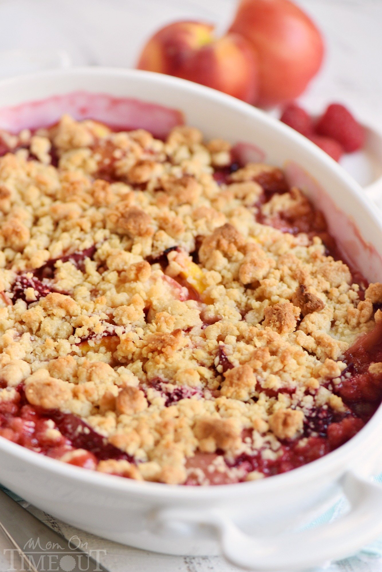 peach-crumble-with-raspberries-brown-sugar topping in casserole dish
