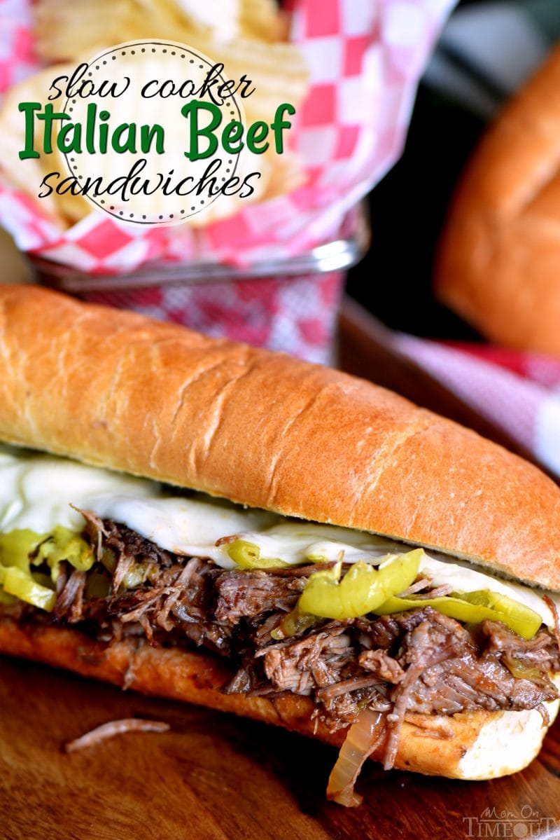 italian-beef-recipe-in roll- with cheese-and peppers on cutting board