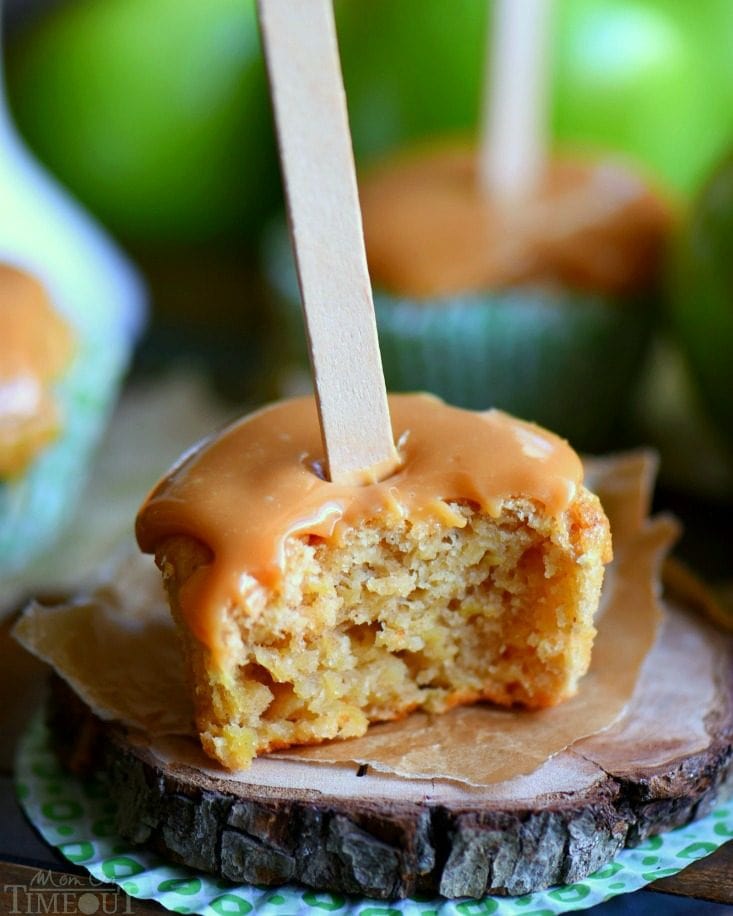 There is no better way to usher in fall than with these delicious Caramel Apple Cupcakes. Moist cupcakes loaded with apples and applesauce for double the apple flavor. A decadent caramel frosting tops them off beautifully. Popsicle sticks not optional. // Mom On Timeout #apple #cupcake