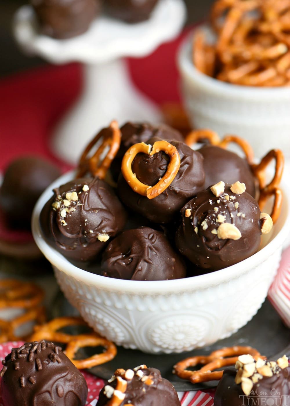 Peanut Butter Balls are taken to the next level with the addition of pretzels in this easy Chocolate Pretzel Peanut Butter Balls recipe. The creamy, crunchy, salty, sweet combination is the best of all worlds. Extra delicious and loaded with peanut butter, chocolate chips, and pretzels! // Mom On Timeout 