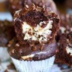 chocolate muffin split in half to show cheesecake filling