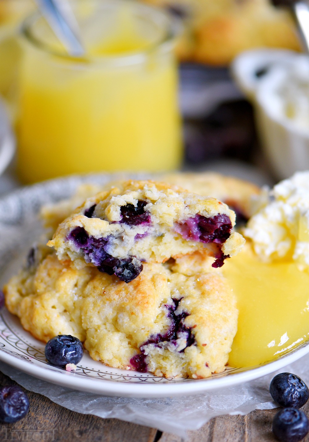 Lemon Blueberry Scones are a delightful addition to any breakfast or brunch! Fresh blueberries and loads of lemon zest add an irresistible freshness to these easy to make scones. Serve with lemon curd and cream for an afternoon tea experience everyone will love! // Mom On Timeout #brunch #breakfast #tea blueberry-scones-with-lemon