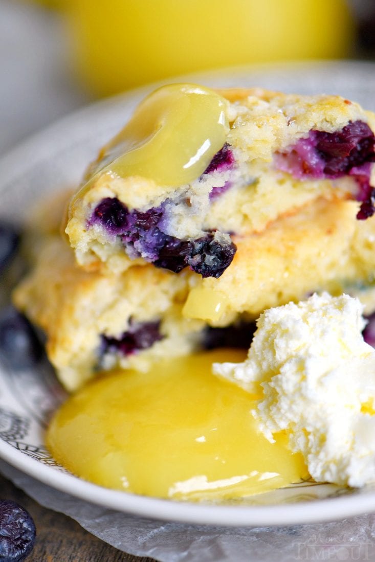 lemon-blueberry-scones with lemon curd and devonshire cream on a plate