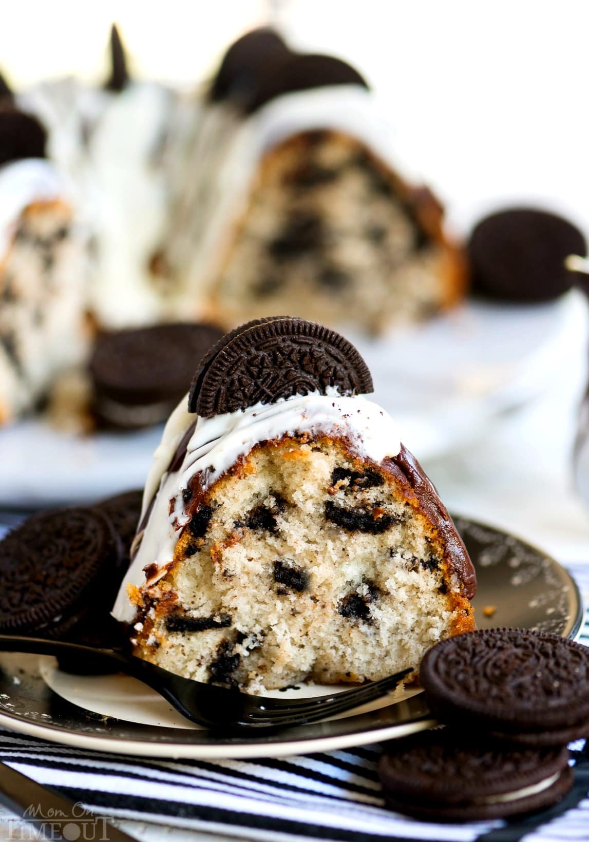 slice-of-oreo-bundt-cake close up with glaze and topped with an oreo
