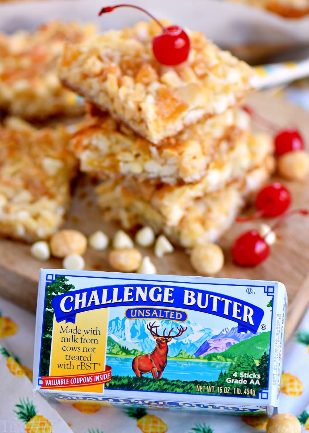 These easy Piña Colada Magic Bars marry the flavors of a Piña Colada with your favorite 7 layer bars. pina-colada-bars-challenge-butter