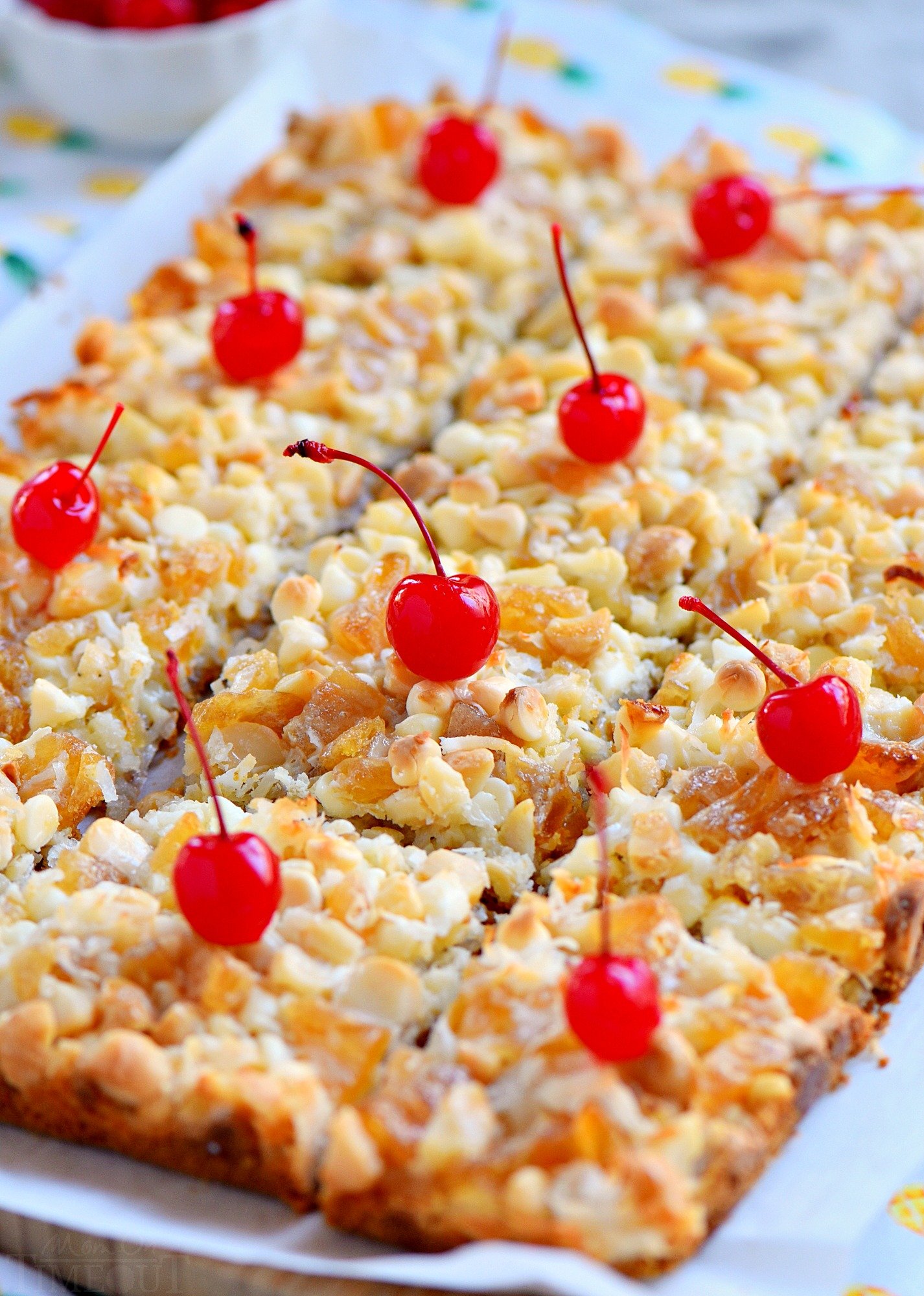 These easy Piña Colada Magic Bars marry the flavors of a Piña Colada with your favorite 7 layer bars. Soft and chewy with a taste of the tropics that everyone will love! cut-pina-colada-bars