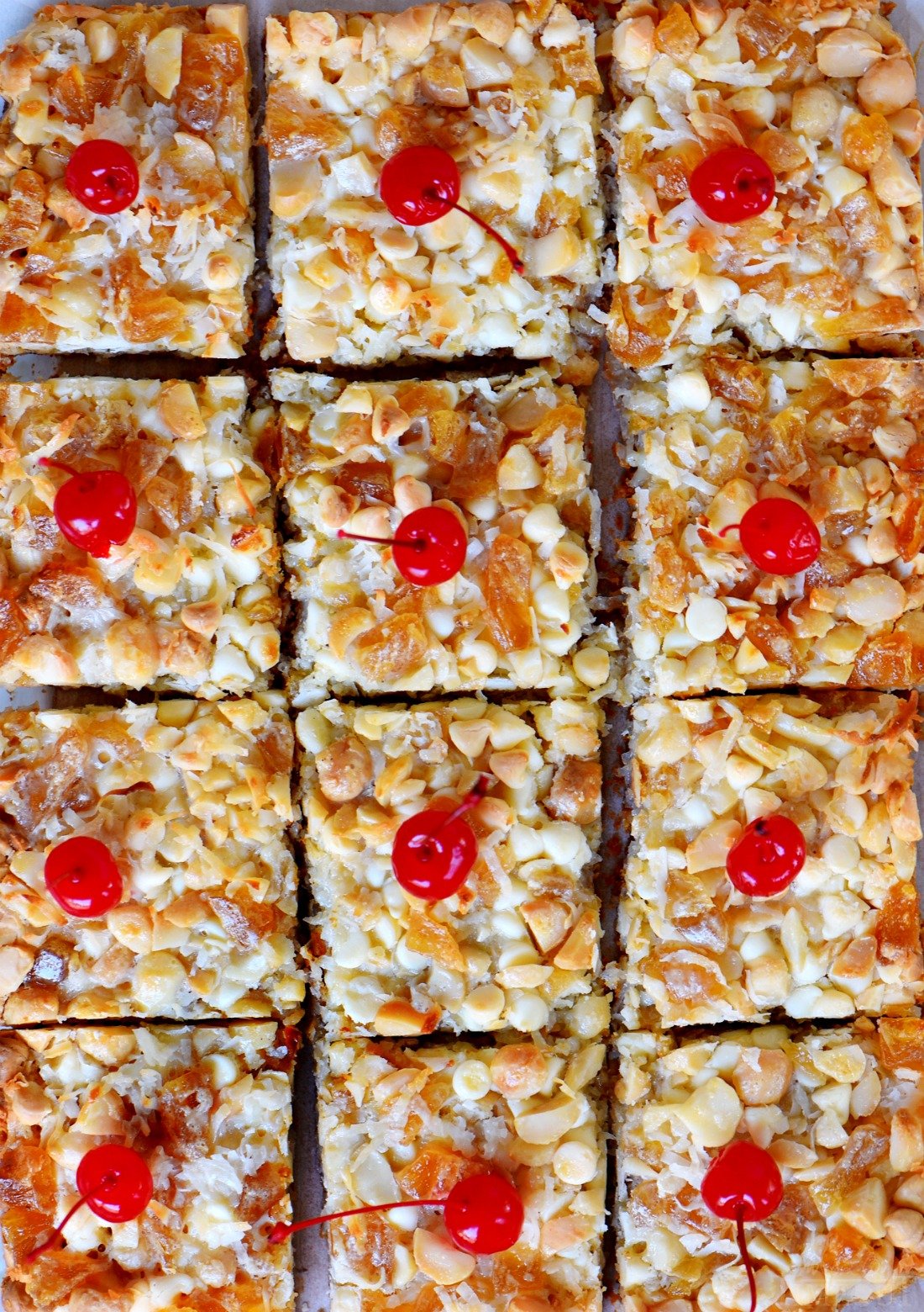These easy Piña Colada Magic Bars marry the flavors of a Piña Colada with your favorite 7 layer bars. Soft and chewy with a taste of the tropics that everyone will love! // Mom On Timeout #ad #recipe #dessert #desserts #pineapple #coconut #rum #macadamia #nuts #bars #recipes #sweets #treats #magic #momontimeout favorite-pina-colada-bars