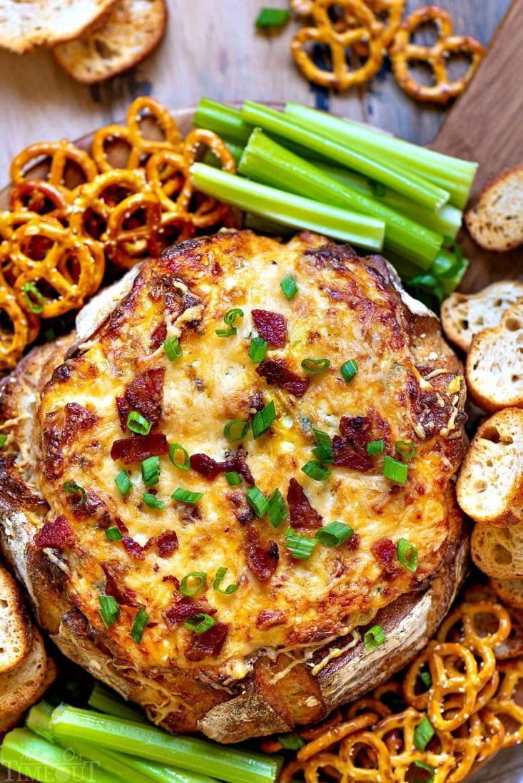This Baked Bacon Cheese Dip is the ULTIMATE party food. This creamy cheese dip is made with five different types of cheese, is loaded with bacon and baked up in a bread bowl that makes serving a breeze. Use your choice of dippers including fresh veggies, chips, pretzels, crostini, or fresh bread. You simply can't go wrong. // Mom On Timeout #bacon #cheese #appetizer #bread #dip #recipe #recipes #appetizers #ad baked-bacon-cheese-dip-recipe-bread-bowl