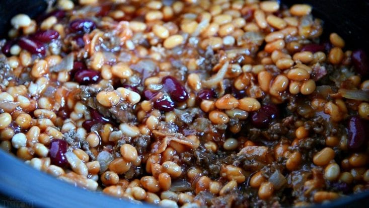 This easy Calico Beans recipe is so hearty and filling and just perfect for chilly weather! Loaded with three types of beans, bacon, and beef! calico-beans-crockpot
