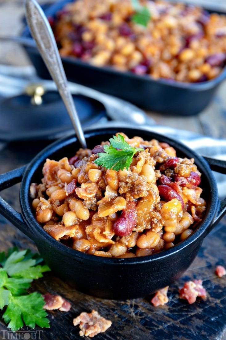 The very best Slow Cooker Cowboy Beans! This easy recipe is so hearty and filling and just perfect for chilly weather! Loaded with three types of beans, bacon, and beef, this family favorite is frequently served up at holiday gatherings, potlucks, and parties and is a must for game day. // Mom On Timeout #slowcooker #crockpot #beans #beef #bacon #gameday #dinner #dinnerideas #dinnerecipes #recipe #recipes slow-cooker-cowboy-beans