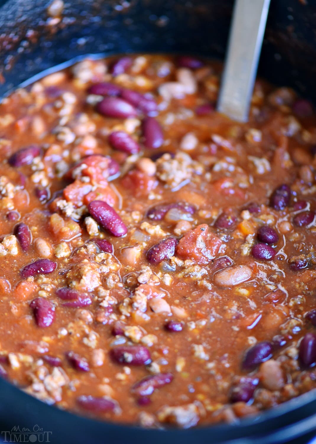 chili recipe cooked in a crockpot ready to be enjoyed.