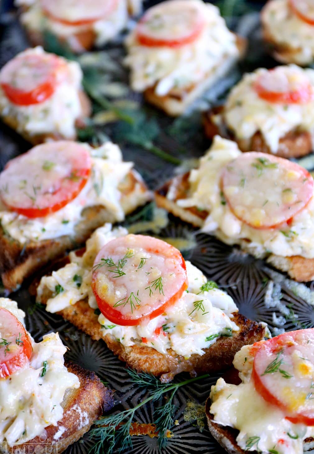 Easy Crab Melts are perfect for entertaining! Sourdough bread is topped with fresh crab, herbs, tomato and Gruyere cheese. Exceptionally delicious! // Mom On Timeout #crab #appetizer #recipe #recipes #ad crab-melt-recipe-tomatoes-dill-gruyere-baking-sheet