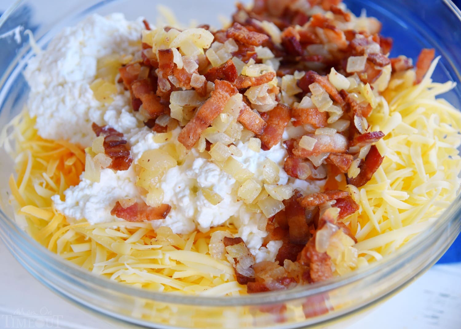 Easy Hashbrown Breakfast Casserole is perfect for entertaining a crowd or serving up a simple weekend brunch. Made with frozen hashbrowns, eggs, bacon, and three different types of cheese, this savory breakfast casserole can be made in advance and is designed to feed a crowd. // Mom On Timeout #breakfast #brunch #bacon #cheese #recipe #recipes #Easter #Christmas #hashbrowns #easy #momontimeout #ad easy-breakfast-casserole-ingredients-in-bowl
