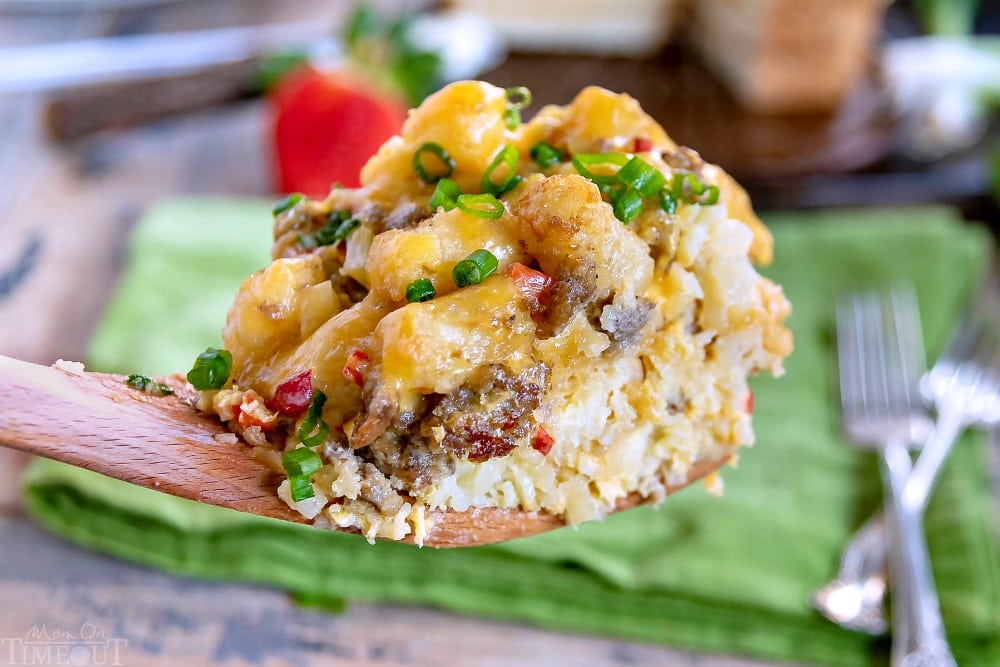 This delicious Slow Cooker Tater Tot Breakfast Casserole is an easy, comfort food dish that is perfect any day of the week. Loaded with eggs, sausage, cheese and tater tots, this simple breakfast casserole is served up straight from your slow cooker! // Mom On Timeout #slowcooker #tatertotcasserole #breakfastcasserole #breakfast #slowcooker #crockpot #tatertots #sausage #cheese #brunch breakfast-tater-tot-casserole-scoop-from slow cooker
