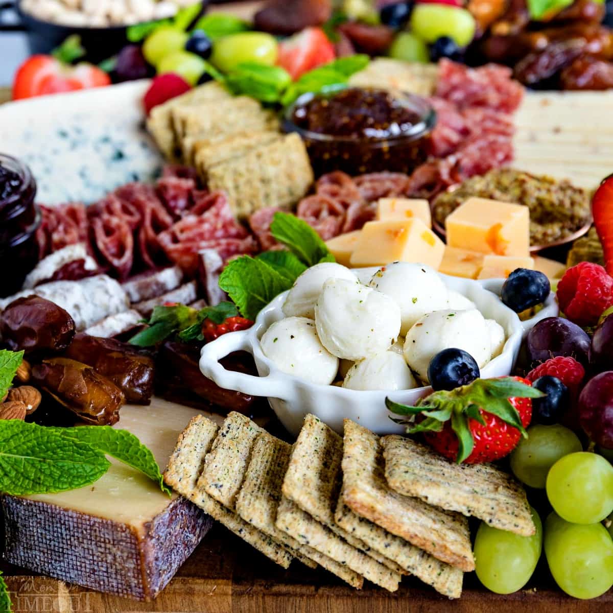 charcuterie-board-with-triscuit-crackers-mozzarella-balls-dates-grapes