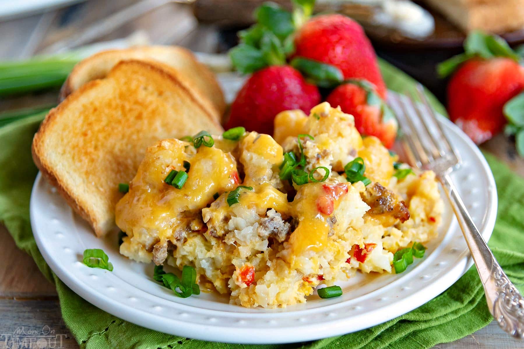 This delicious Slow Cooker Tater Tot Breakfast Casserole is an easy, comfort food dish that is perfect any day of the week. Loaded with eggs, sausage, cheese and tater tots, this simple breakfast casserole is served up straight from your slow cooker! // Mom On Timeout #slowcooker #tatertotcasserole #breakfastcasserole #breakfast #slowcooker #crockpot #tatertots #sausage #cheese #brunch tater-tot-breakfast-casserole-slow-cooker-plated-wide