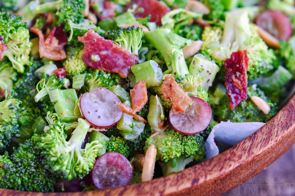 close up view of broccoli salad made with red grapes, bacon, celery and a tangy dressing.