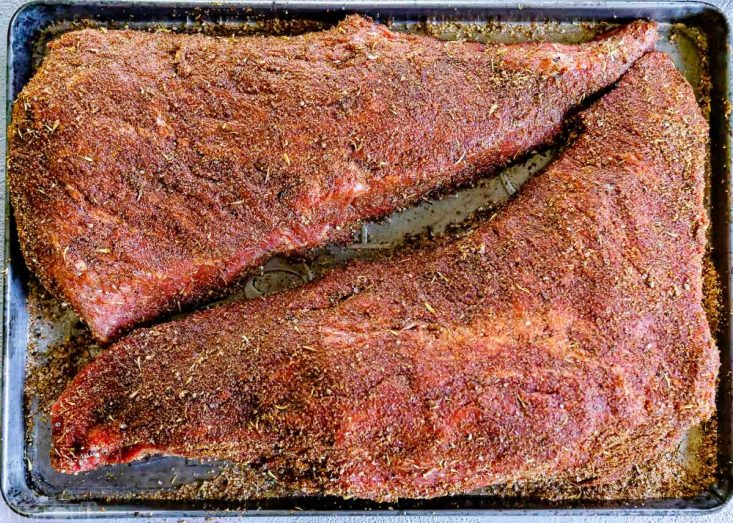 tri tip rubbed with steak seasoning on baking sheet