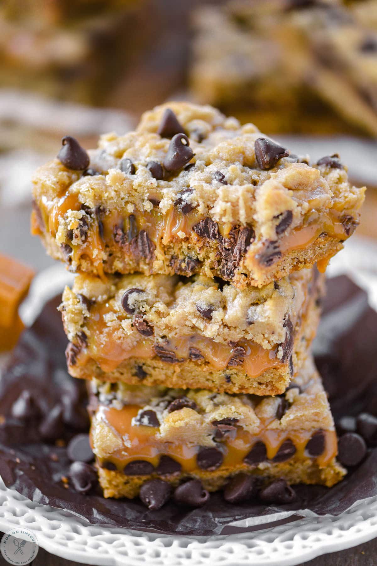 Carmelita bars stacked three high with top bar having several bites taken out of it. 
