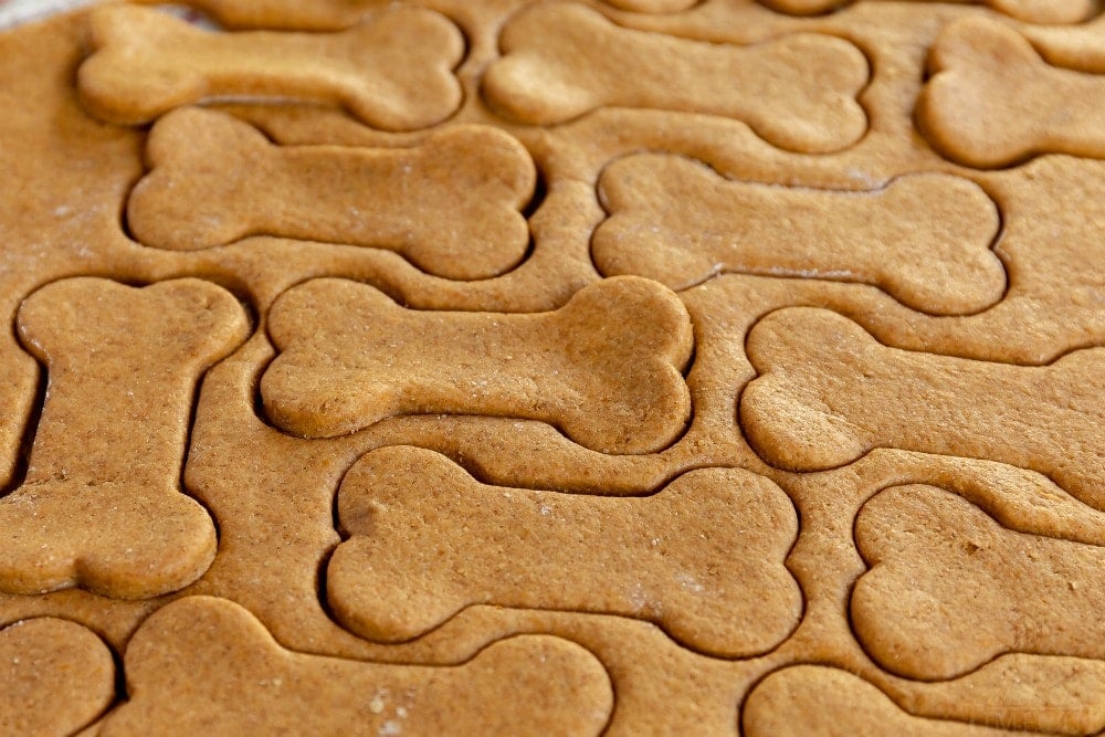 These Homemade Dog Treats are made with peanut butter and pumpkin and are sure to be a hit! This easy recipe is made in one bowl with just 5 ingredients - simple and delicious! // Mom On Timeout #dogtreats #homemadedogtreats #pumpkin #peanutbutter #dogs #dog #peanutbutterdogtreats #pumpkindogtreats #ad homemade dog treats dough cut out
