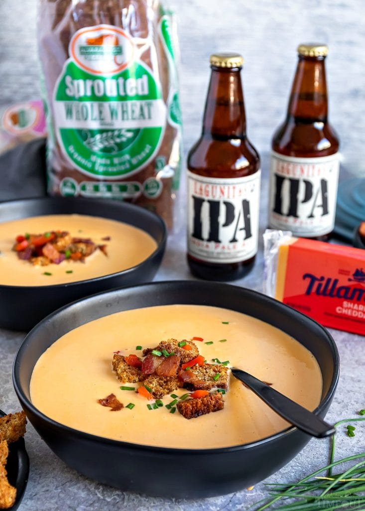 This easy Beer Cheese Soup is the perfect way to warm up on a chilly, fall day. Loaded with bacon, beer and cheese, this comforting soup is perfect for game day! // Mom On Timeout #beercheesesoup #souprecipes #soup #dinner #beer #bacon #cheese beer cheese soup with bacon croutons in bowl
