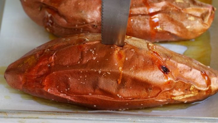 baked sweet potato with knife in it