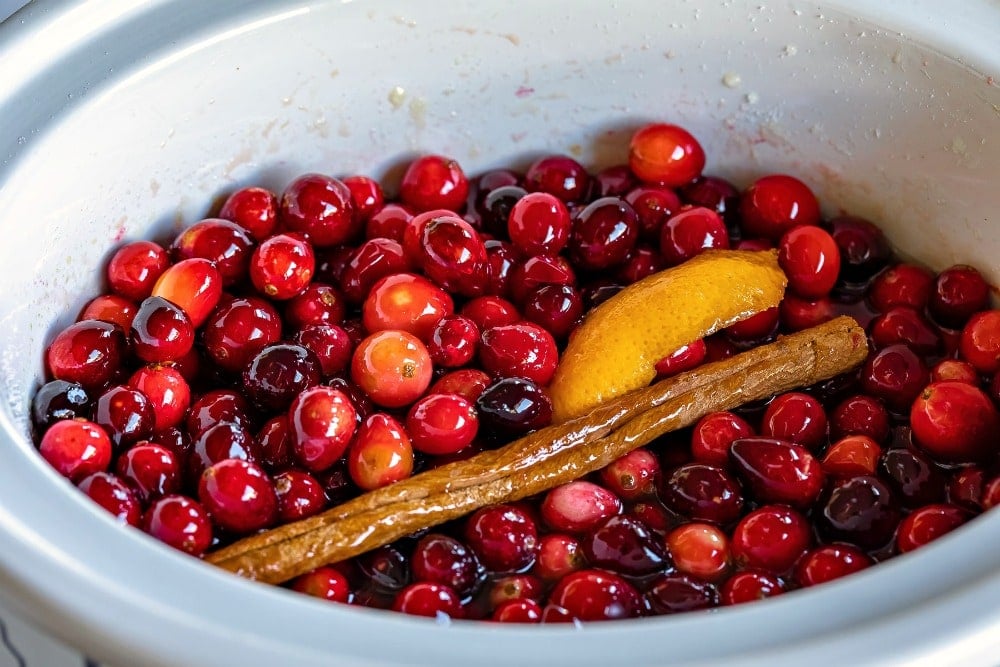 cranberry sauce ingredients stirred together in crockpot