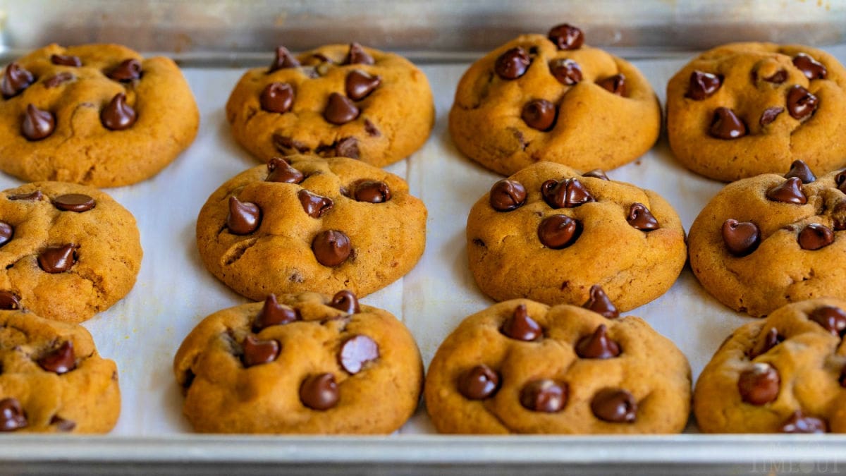 baked pumpkin chocolate chip cookies on quarter sheet pan.
