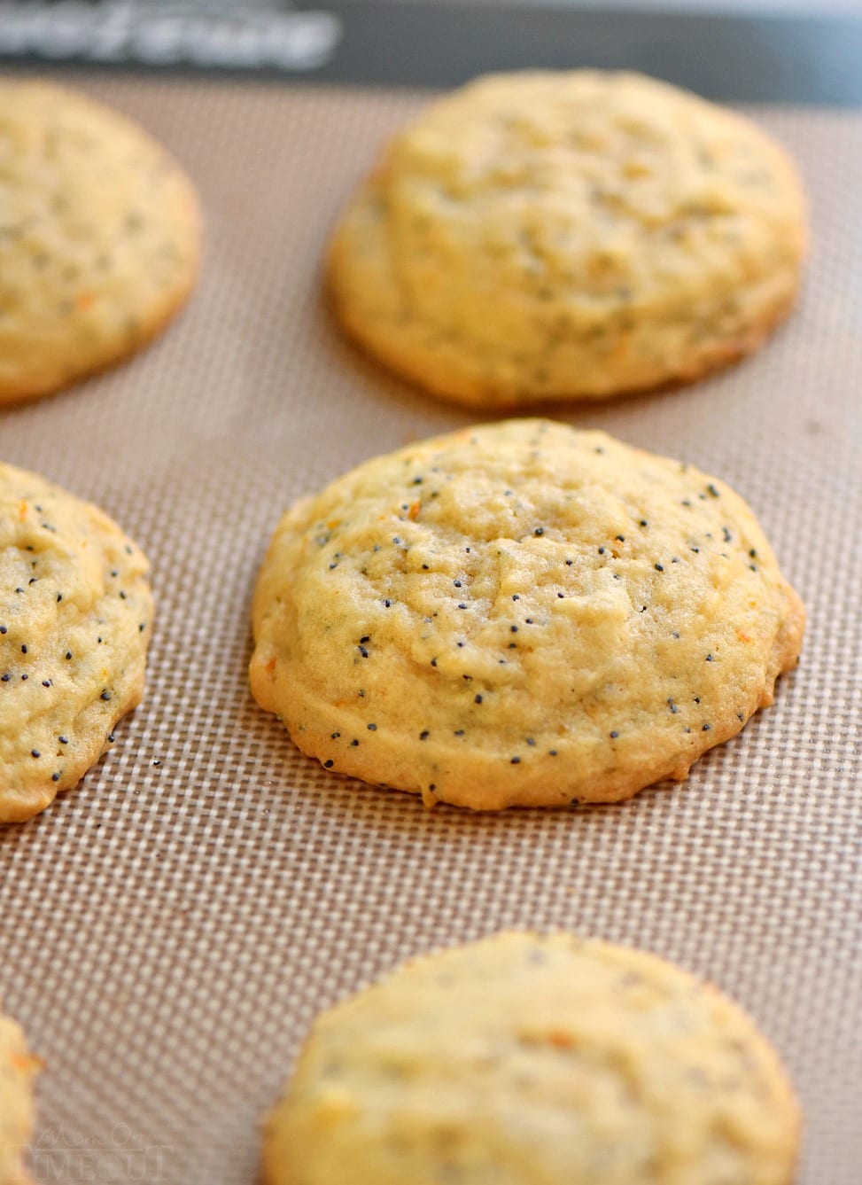 orange poppy seed cookies on silicone baking mat baked