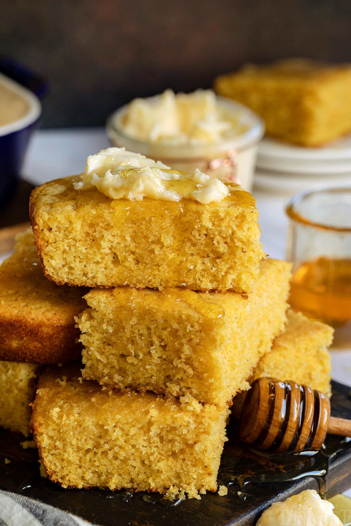 cornbread recipe stacked with honey drizzling and butter