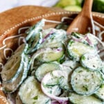 cucumber salad in wood bowl text on image