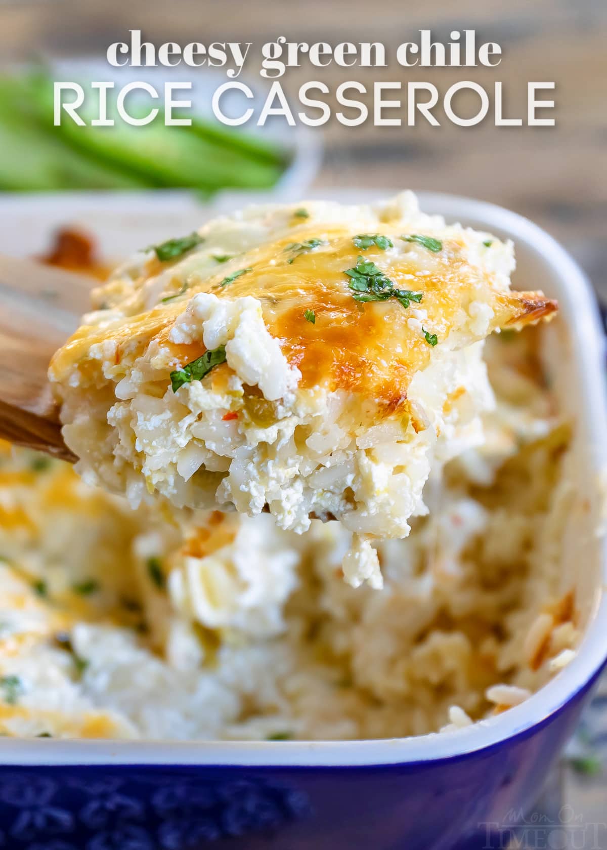 scoop of casserole on wood spoon with casserole dish in background and text overlay at top of image