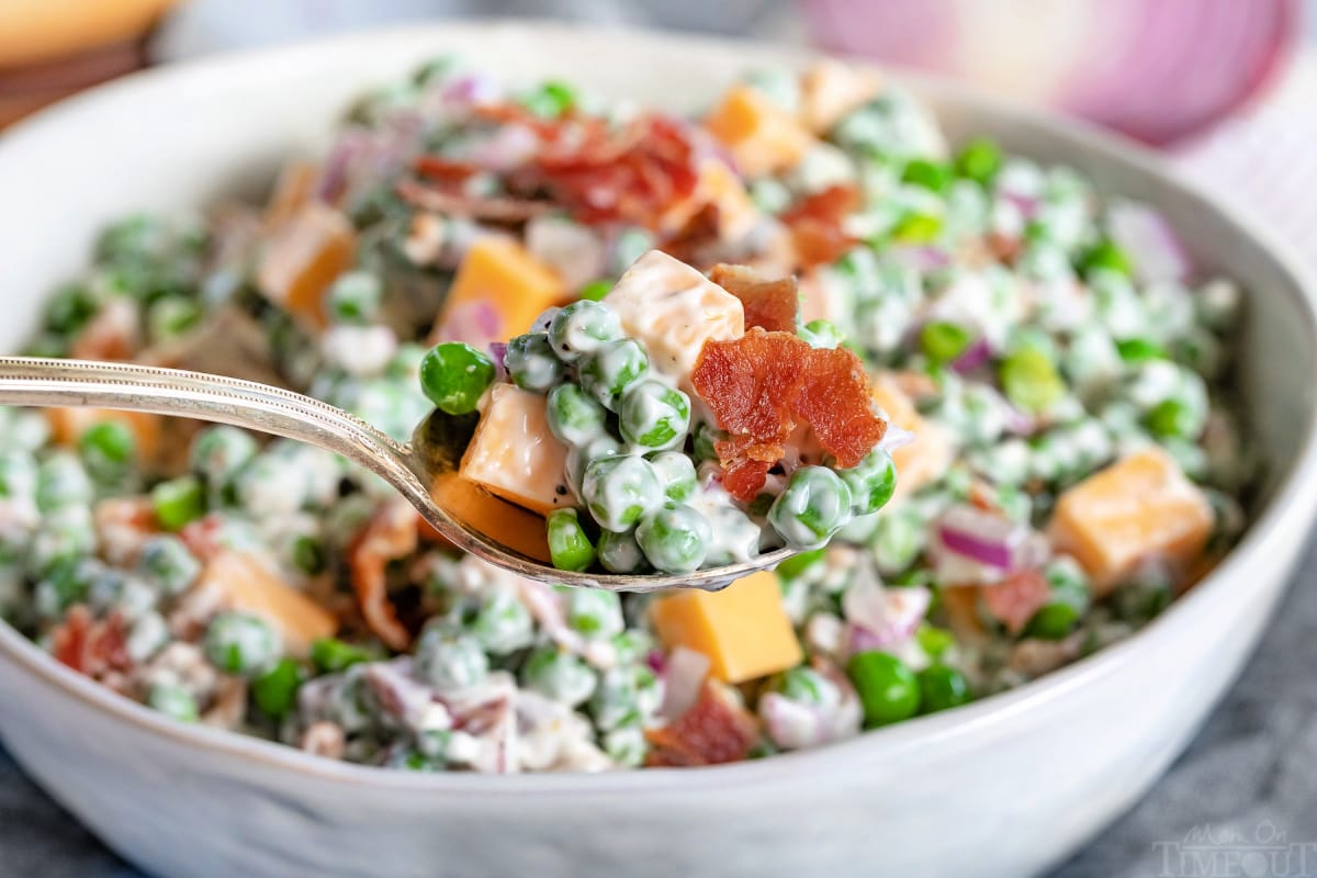 spoonful of pea salad with bowl in background