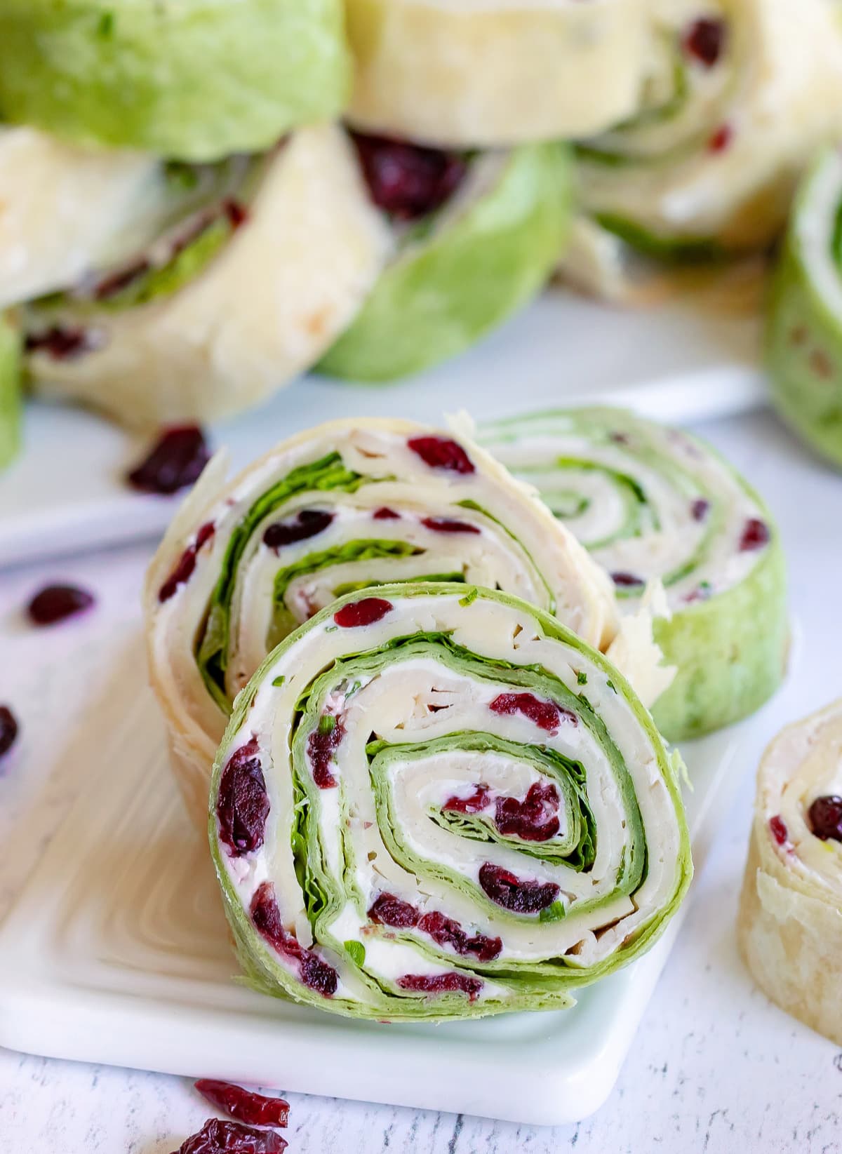 turkey pinwheels recipe with dried cranberries on small white board