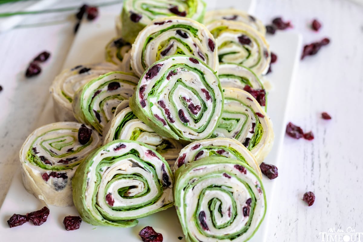 turkey pinwheels stacked high on a white cutting board