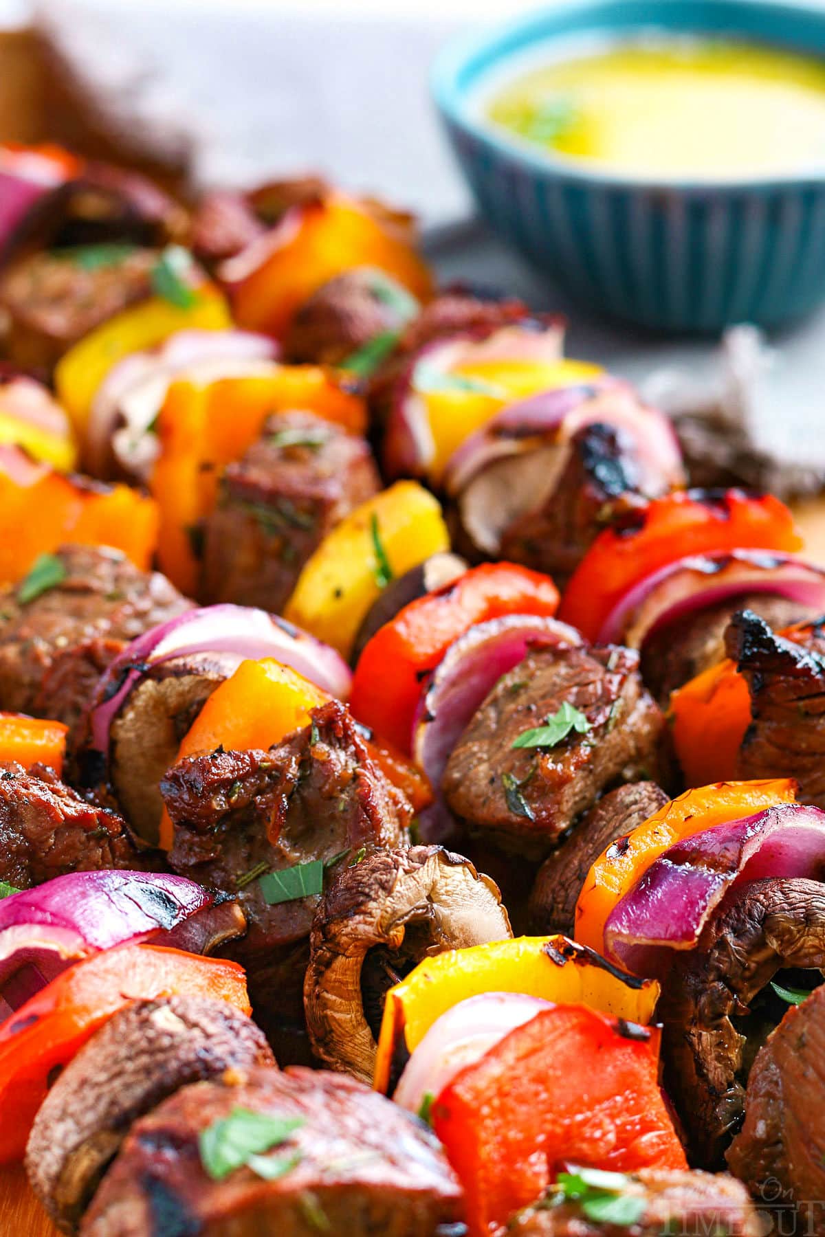 close up of several steak kabobs on skewers