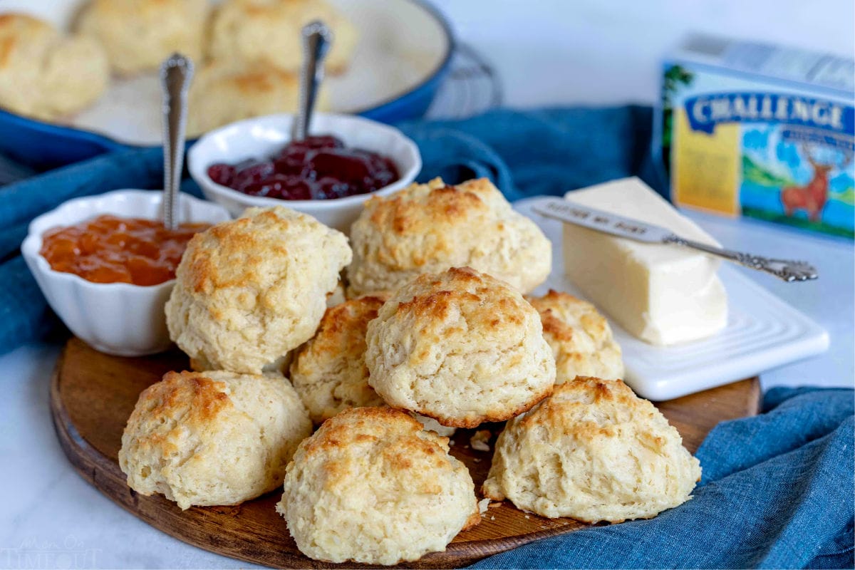 drop biscuits on wood board with jelly and butter