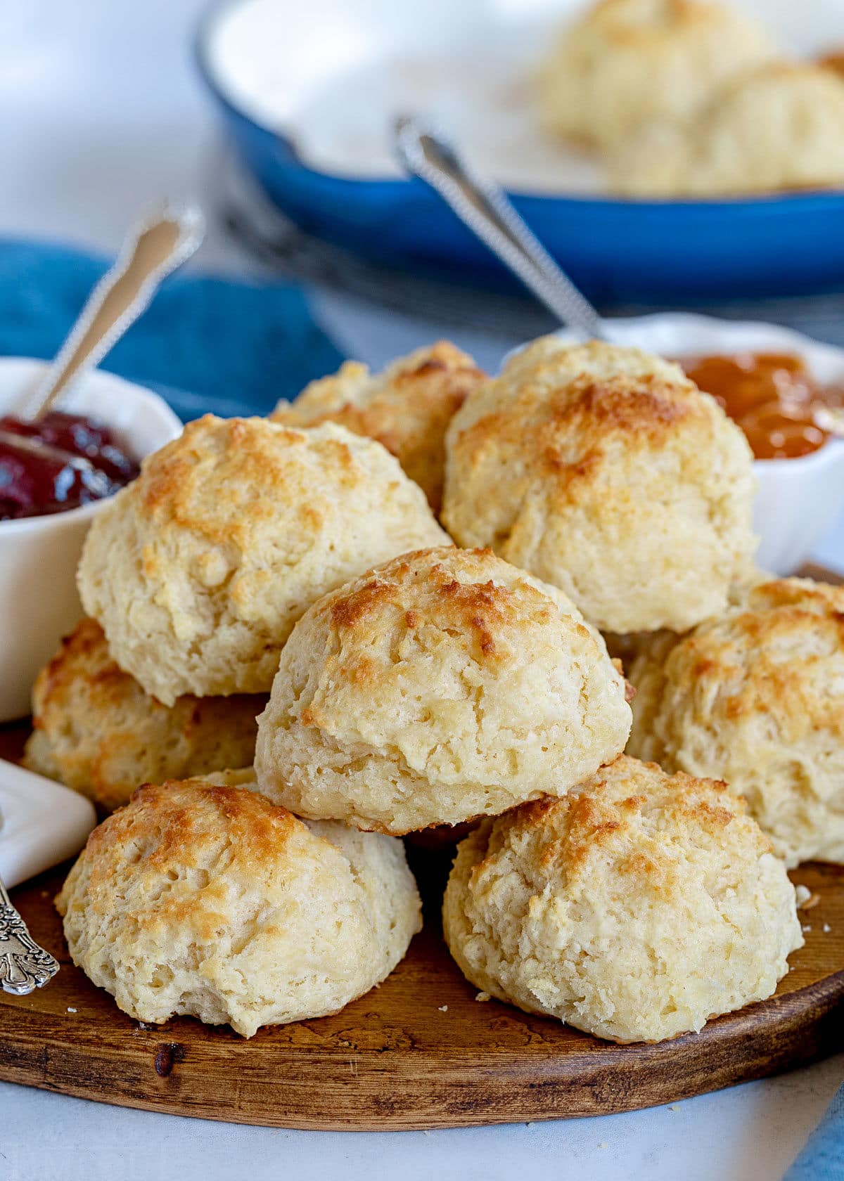 drop biscuits piled high on round wood board