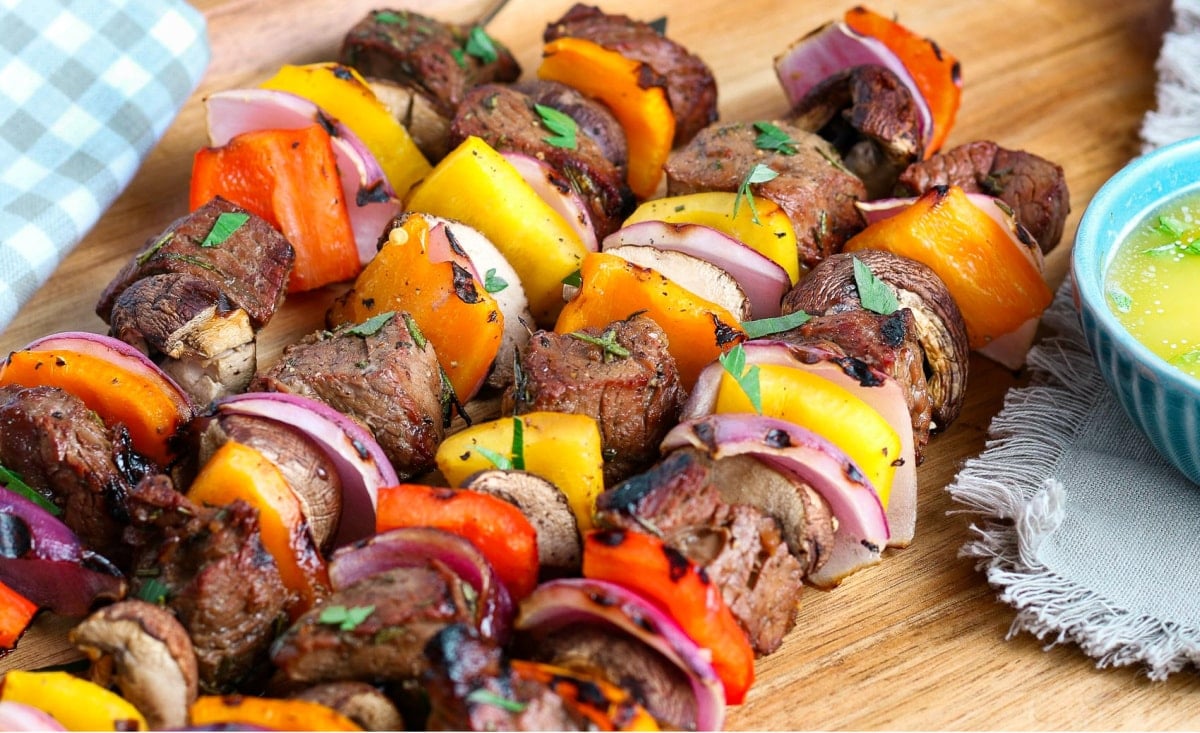 easy steak kabobs grilled and ready to eat on wood plate