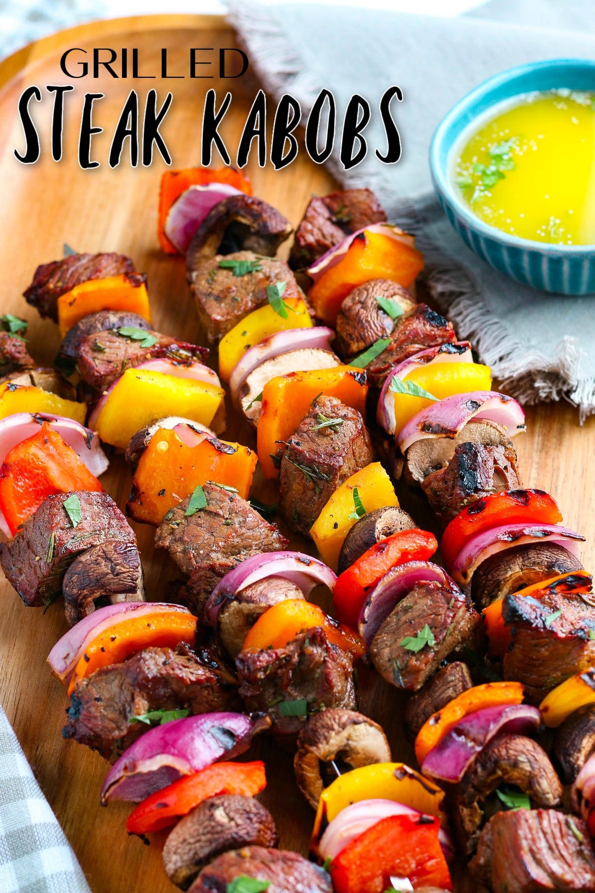 grilled steak kabobs ready to eat on wood plate with text overlay