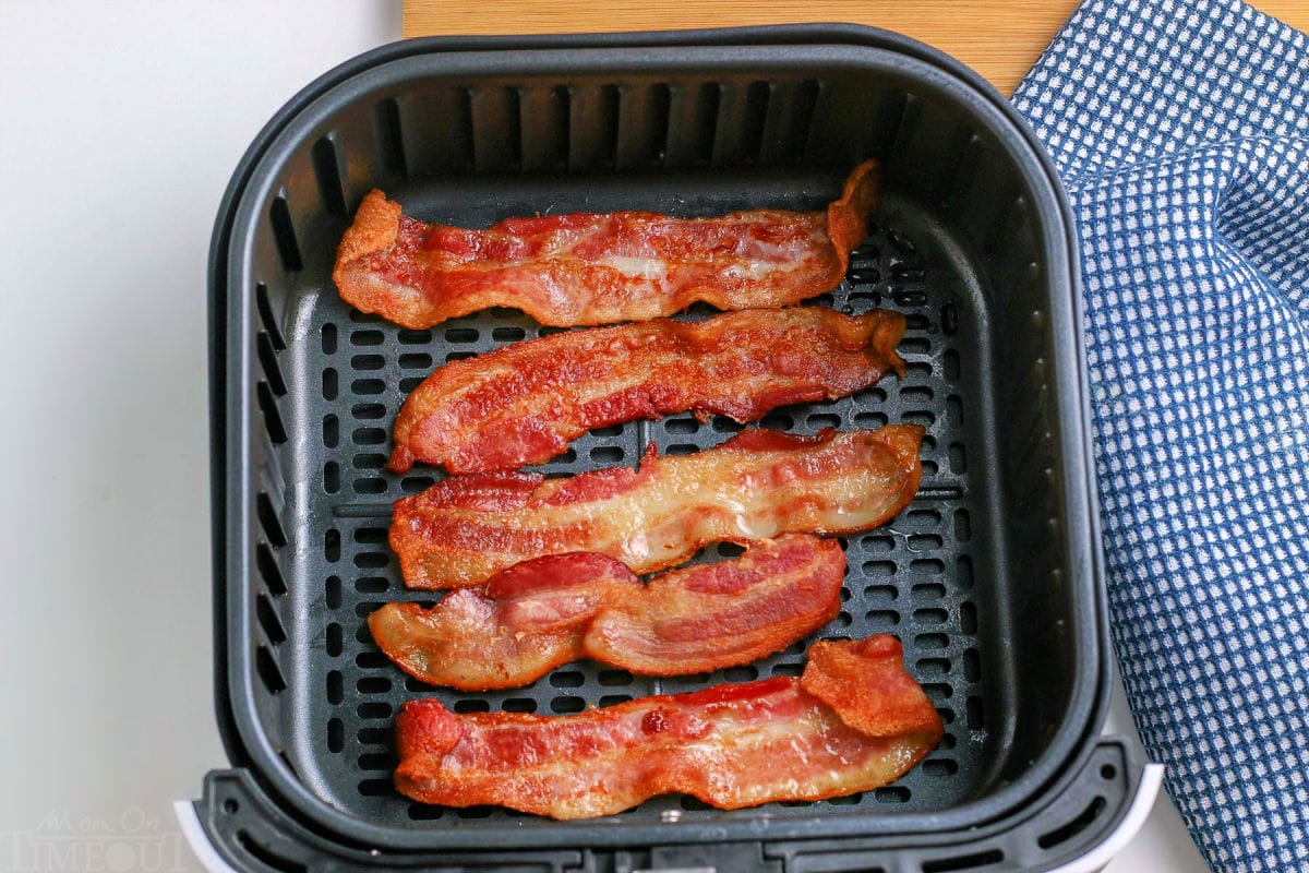 cooked bacon in an air fryer basket