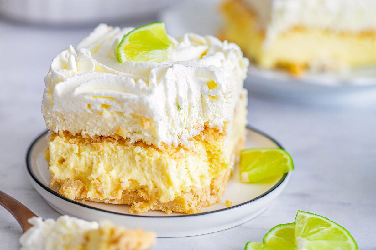 piece of key lime lush recipe on white plate with bite taken