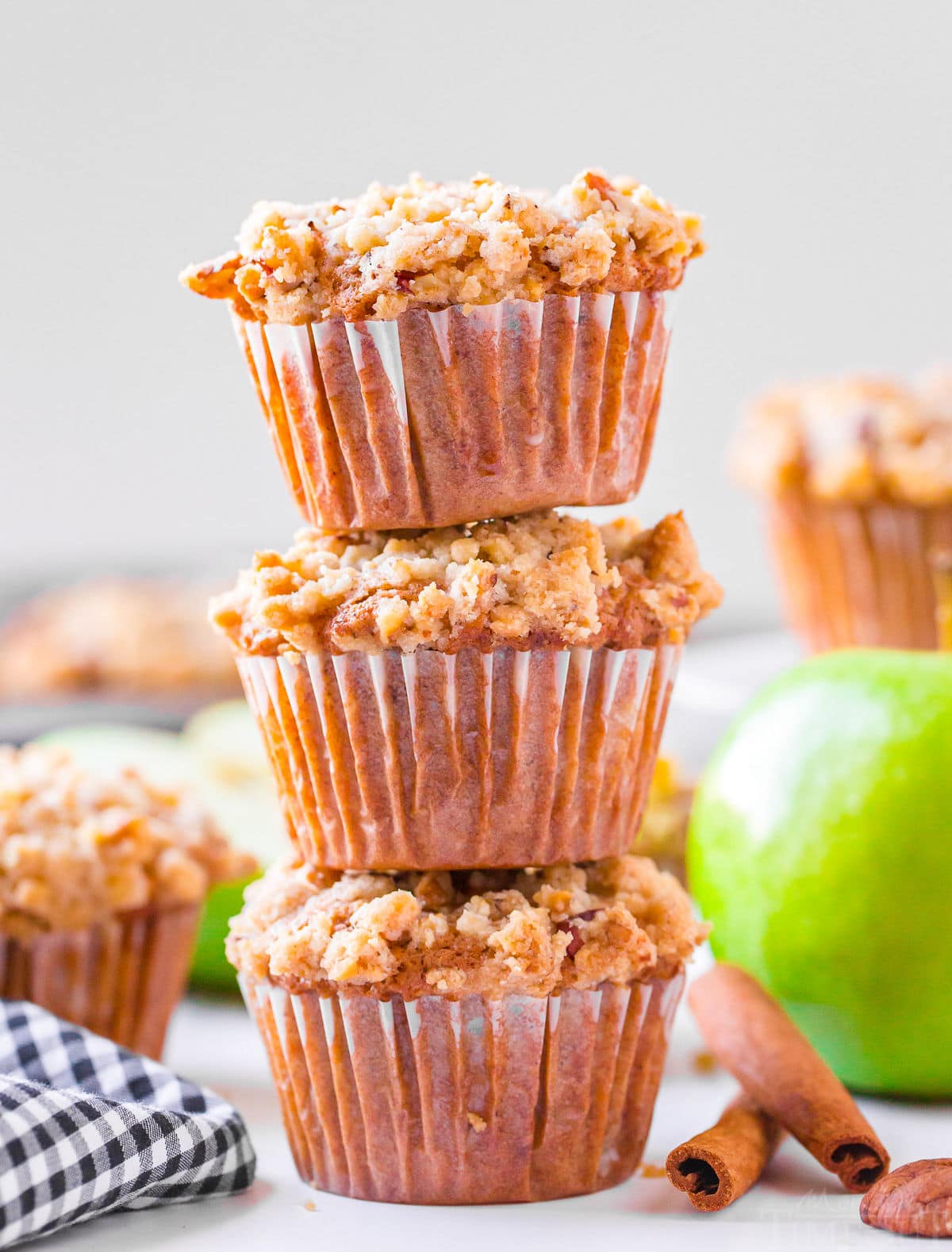 apple muffins-stacked three high with more muffins in background