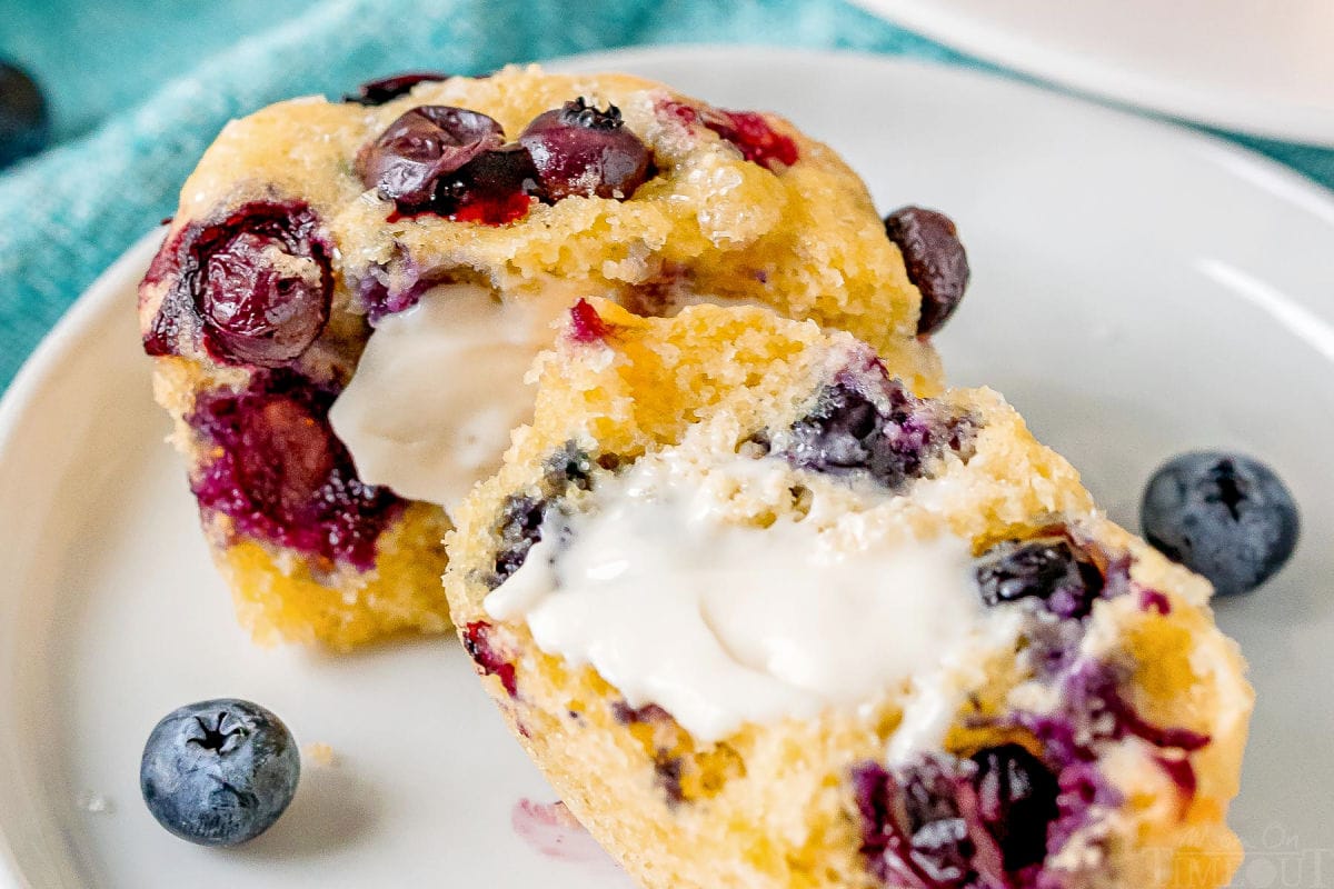 corn muffins with blueberries split in half and buttered on white plate