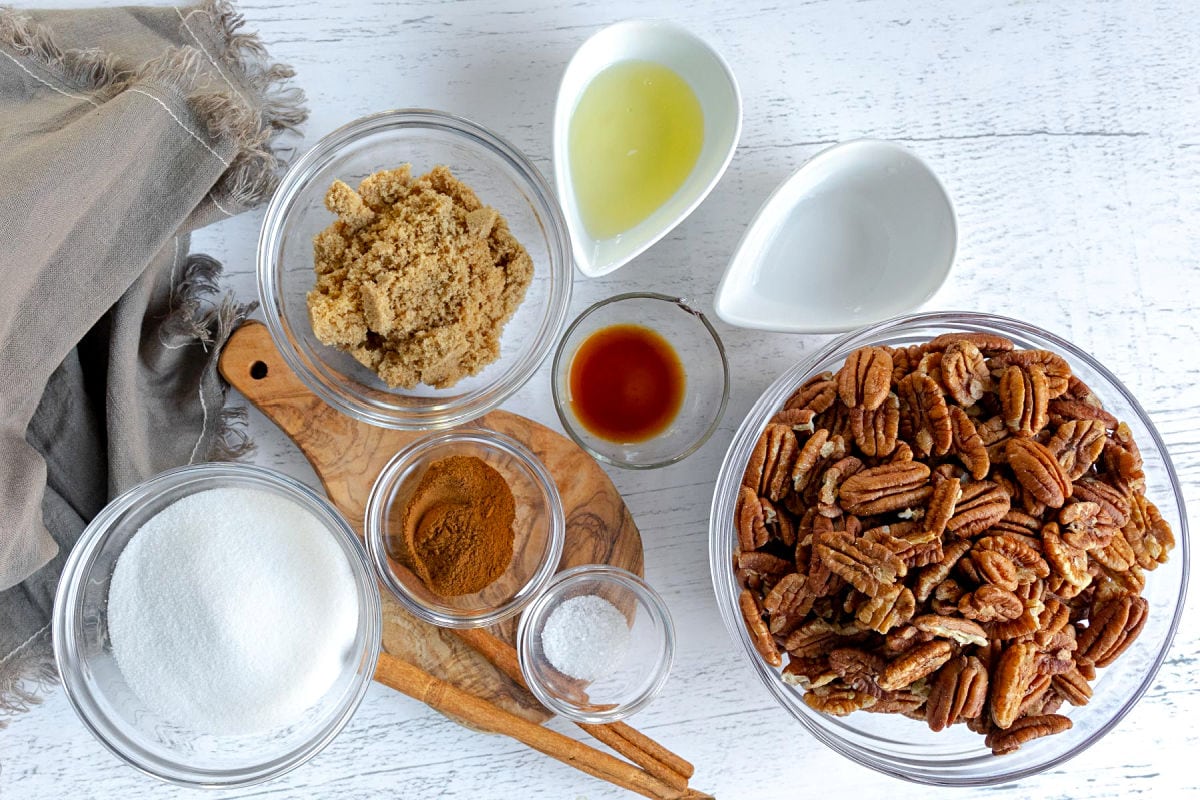 candied pecans ingredients measured out into small bowls sitting on white surface